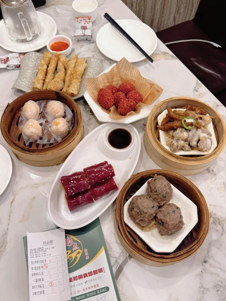 Cantonese dim sum table featuring traditional steamed dishes, tea, and Chinese dining culture