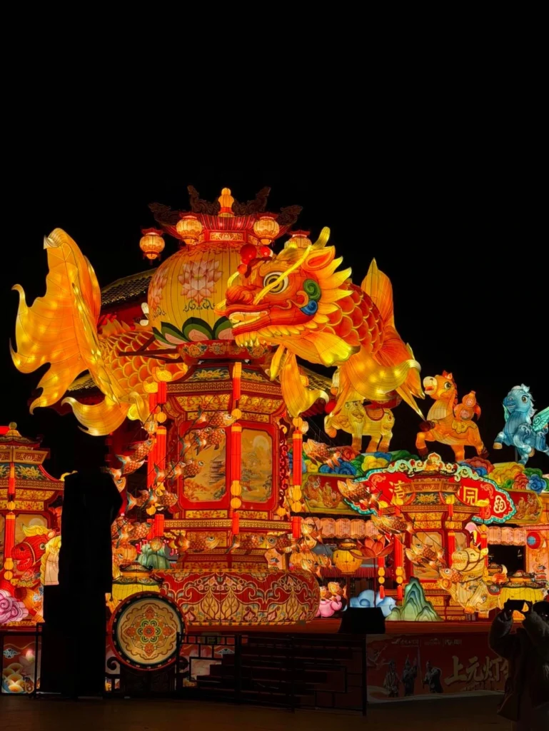 Chinese Lantern Festival night celebration with illuminated dragon lanterns, traditional decorations, and festive crowd gathering
