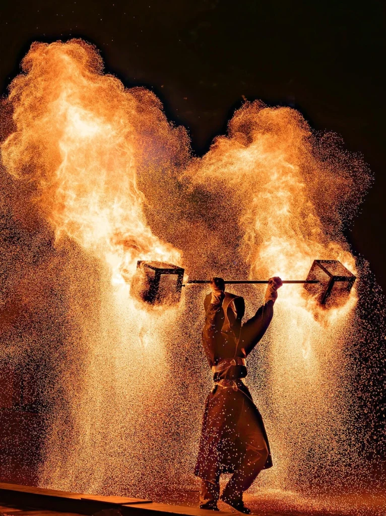Chinese intangible cultural heritage firework performance with molten iron sparks in night sky