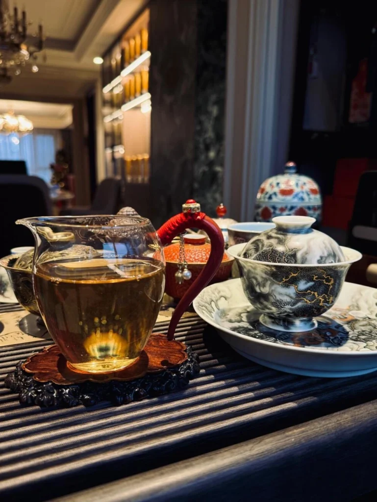Elegant Chinese tea ceremony setup with traditional teaware and brewed tea in warm indoor setting