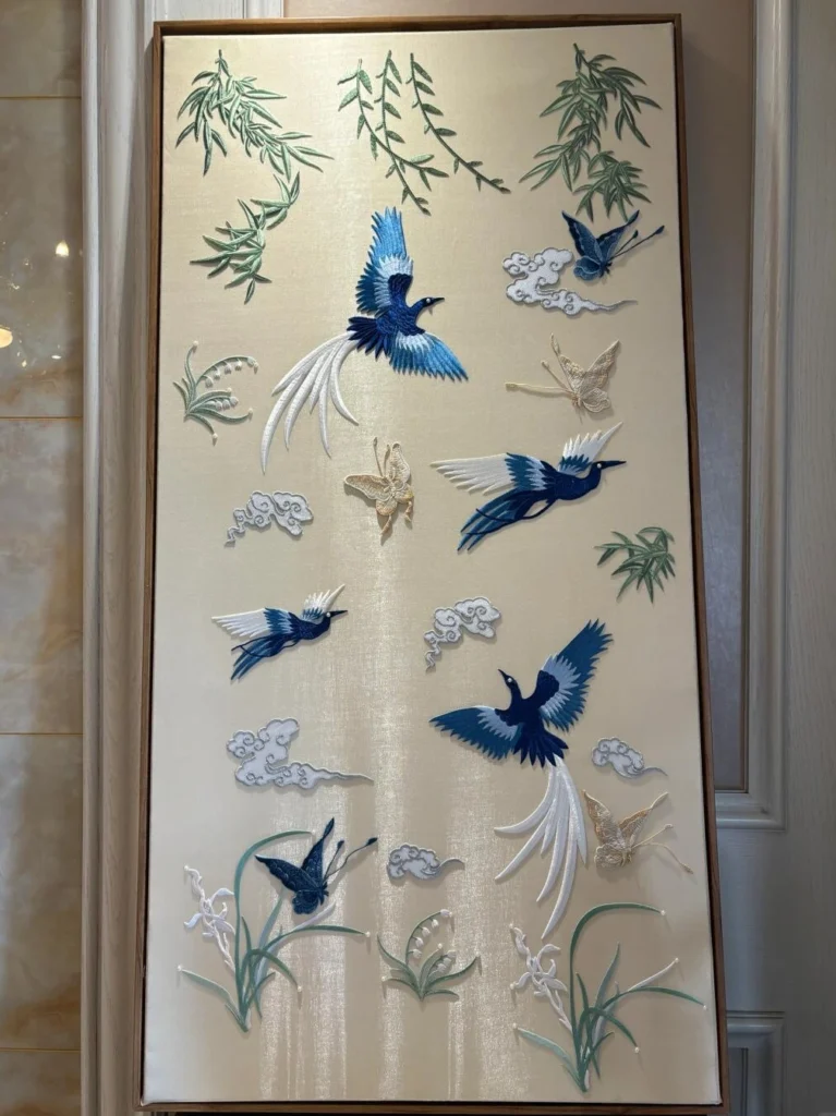 Traditional Chinese embroidery artwork featuring birds, flowers, and intricate silk thread craftsmanship
